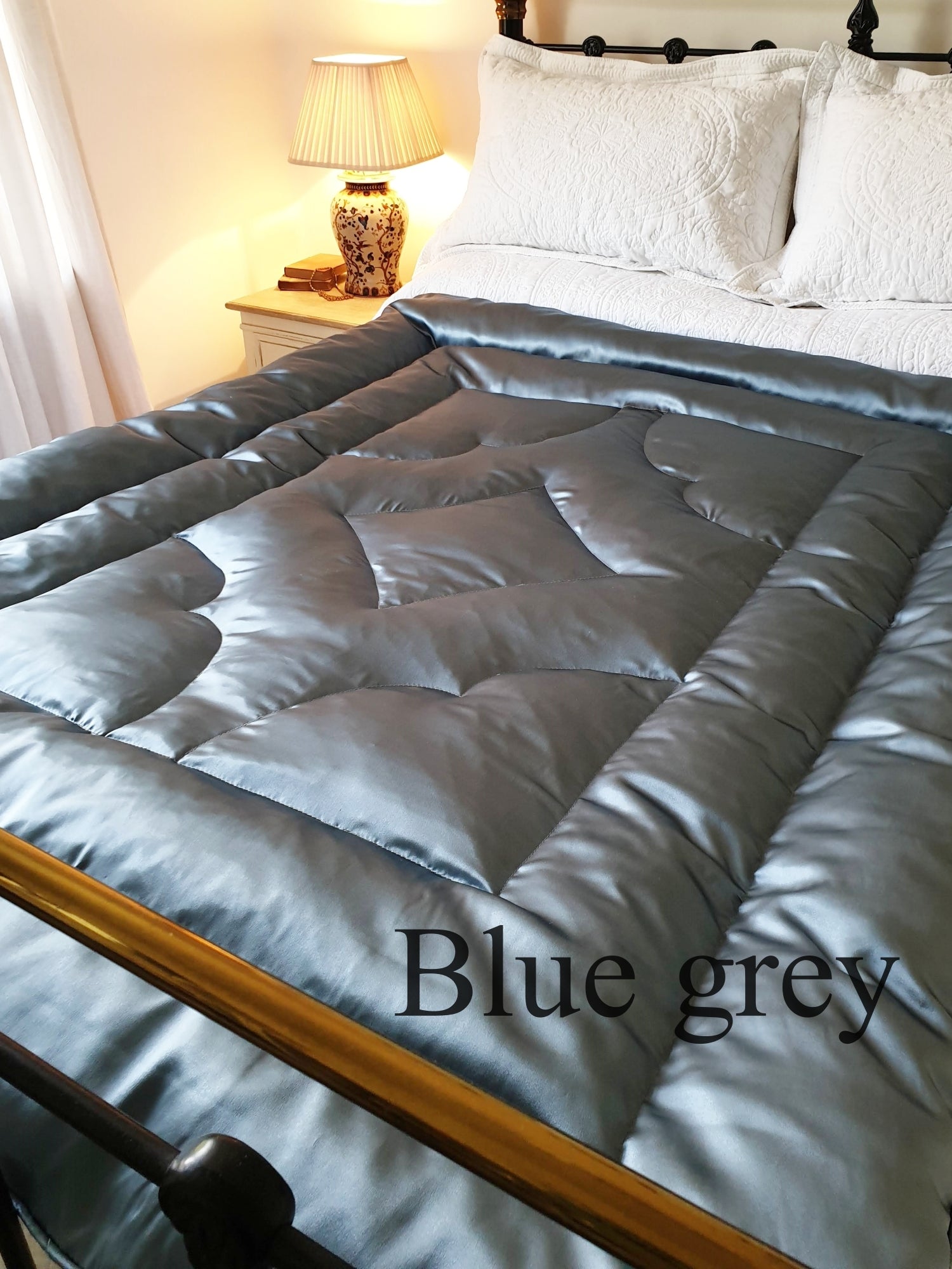 Blue silk satin eiderdown quilt on bed