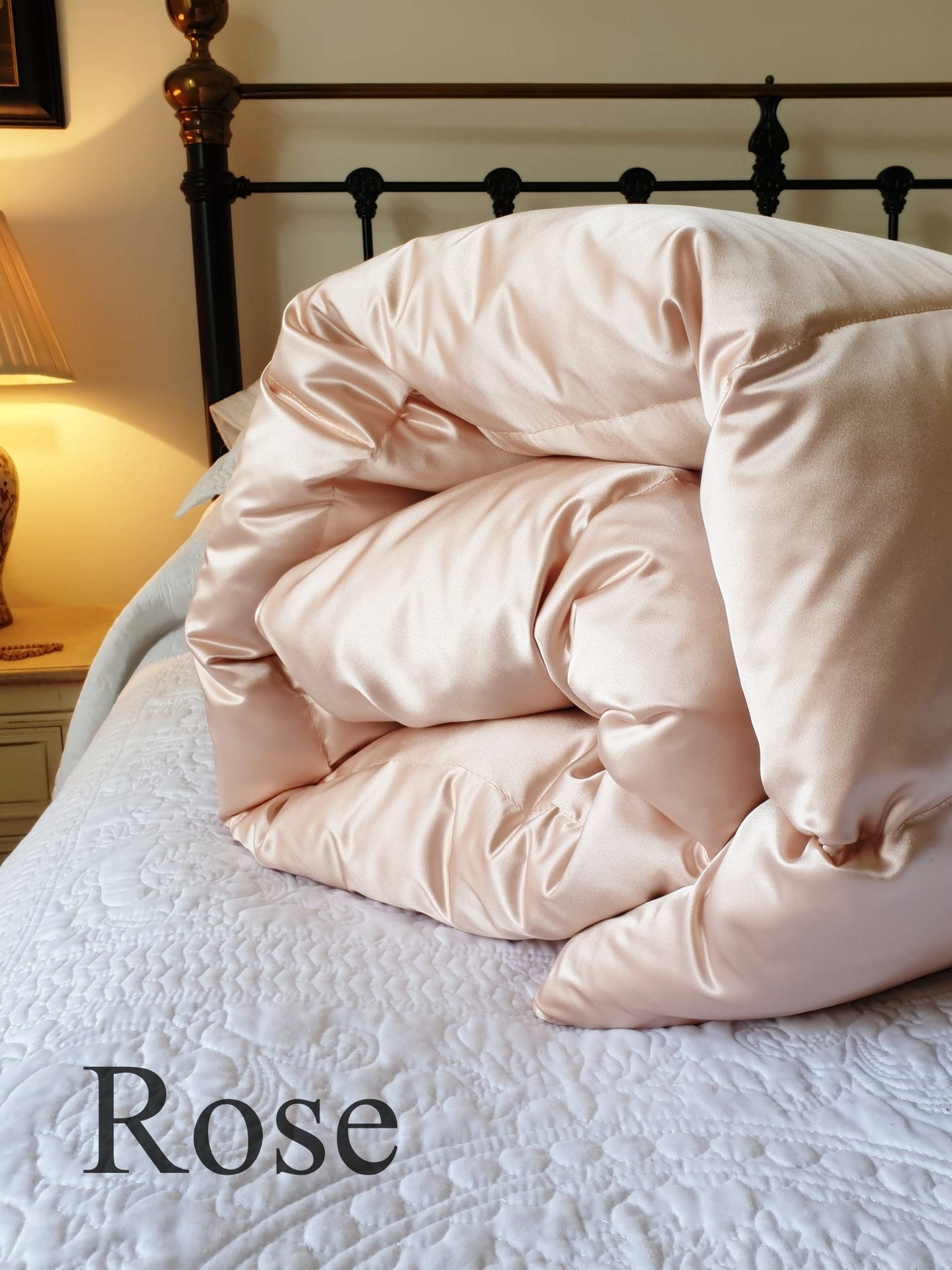 Silk satin eiderdown in Rose on bed