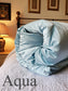 Aqua blue silk eiderdown in bedroom 